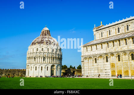 Pisa, Italien - 19. Oktober 2015: Ansicht der Taufkapelle und der Kathedrale von Pisa mit Touristen auf dem Platz der Wunder am 19. Oktober 2015. Stockfoto