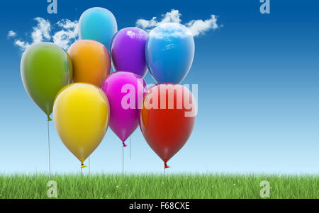 Bunte Luftballons auf blauem Hintergrund mit grass Stockfoto