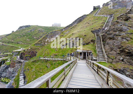 Meer-Nebel und Schritte - die Brücke auf die Insel mit Tintagel Castle ruins, Cornwall, England, UK Stockfoto