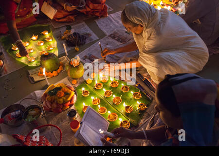 DHAKA, Bangladesch-14. November: Anhänger besuchen Gebet mit brennendem Weihrauch und leichte Öl-Lampen vor Pause Fasten während eines religiösen Festes Rakher Upabash in Dhaka am 14. November 2015 genannt. Bengali Leute des hinduistischen Glaubens in Bangladesch sitzen im Gebet feiern im 18. Jahrhundert hinduistischen Heiligen Baba Lokenath mit "Rakher Upobas" Gebet und Fastentag jedes Jahr Tausende von hinduistischen Anhänger versammeln sich vor Shri Shri Lokenath Ramakrishna Ashram Tempel für das Kartik Brati oder Rakher Upobash religiöse fest in Barodi, in der Nähe von Dhaka, Bangladesh. Gläubigen sitzen vor Kerzen Licht (name Stockfoto