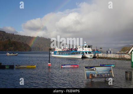 Lake Windermere, Cumbria, UK. 16. November 2015. Großbritannien Wetter. Regenbogen über Lake Windermere. Bowness Bay Promenade unter Wasser im Vordergrund Credit: Gordon Shoosmith/Alamy Live News Stockfoto