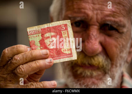 hält eine drei Peso-Banknote mit dem Porträt von Ernesto Che Guevara in der Hand, Landeswährung, CUP, La Habana kubanische Greis Stockfoto