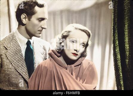 1936, Filmtitel: GARDEN OF ALLAH, Regie: RICHARD BOLESLAWASKI, Studio: UA, im Bild: MARLENE DIETRICH, BASIL RATHBONE, Sorge, SAD, verlassene, CAPE, Augenbrauen, Vorhang, TRÖSTENDE, noch FILM, GELANGWEILT. (Bild Kredit: SNAP) Stockfoto