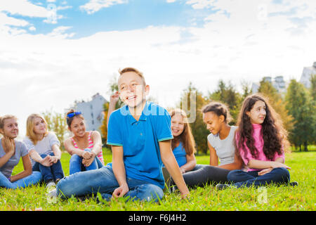 Lachen, junge und Freunde sitzen zusammen im park Stockfoto