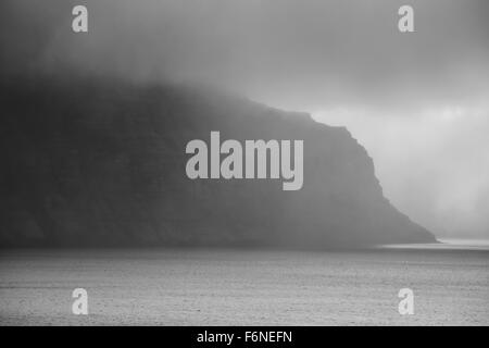 Isländische Fjord mit Nebel schwarz und weiß Stockfoto