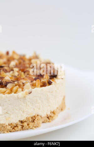 Hausgemachter Kokos Käsekuchen mit Karamell und verschiedenen Nüssen Stockfoto