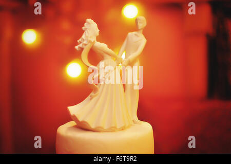 Figur des Brautpaares Hintergrund gelbes Licht Stockfoto