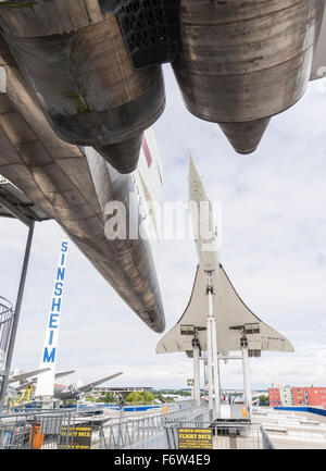 Blick von unten eine ausrangierte russische Tupolew Tu-144 Überschall-Passagierflugzeug auf ihrem westlichen Gegenstück Concorde. Stockfoto