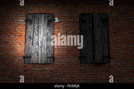 Fenster auf roten Backsteinmauer mit einer Taschenlampe beleuchtet. Stockfoto
