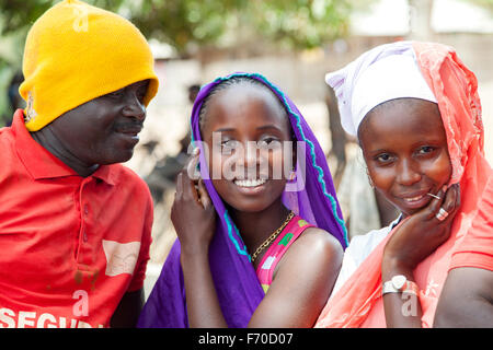 Gabu, Guinea-Bissau - 10. Mai 2014: Mann versucht, mit zwei afrikanischen Mädchen zu flirten. Tägliche Szenen aus ländlichen Guinea-Bissau Stockfoto