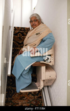 South Asian Lady mit einem Treppenlift, Stockfoto