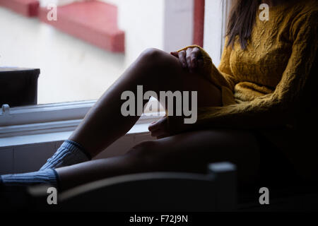 Sitzen Womans Beine Stockfoto