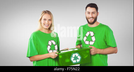 Zusammengesetztes Bild Porträt des Lächelns freiwillige tragen recycling container Stockfoto