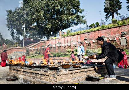 Menschen, die das Ritual der leuchtenden Steingut Lampe nach verehren Gott Shiva in Pashupatinath in Kathmandu durchführen Stockfoto