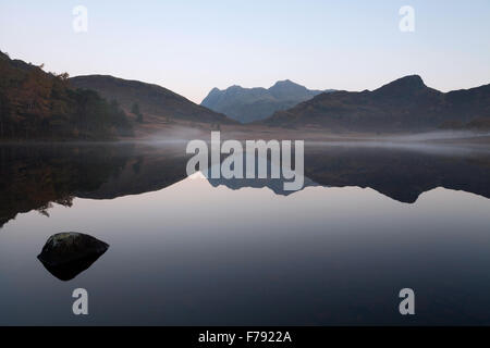 Eine herbstliche Ansicht von Langdale Pikes, Blea Tarn in den Lake District National Park im Morgengrauen entnommen. Stockfoto