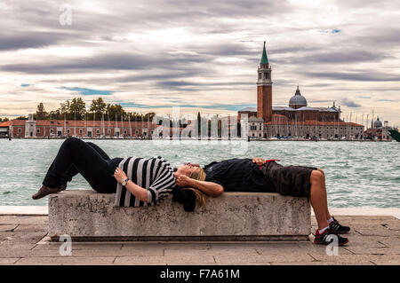 Touristischen paar schlafen oder ruhen auf einer Bank in Venedig, Italien Stockfoto