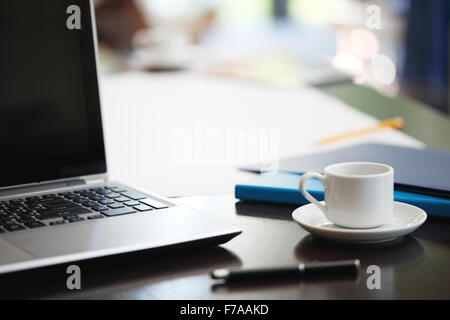 Büroarbeitsplatz mit Laptop und Bürobedarf Stockfoto