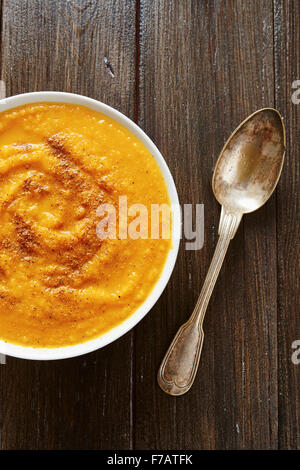 Kürbissuppe in weiße Schüssel mit Brot Croutons auf Holztisch Stockfoto