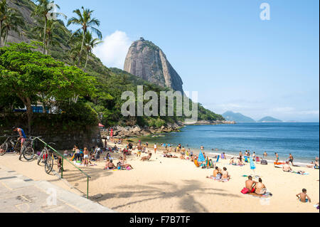 RIO DE JANEIRO, Brasilien - 20. Oktober 2015: Beachgoers entspannen auf Praia Vermelha Red Beach unter einen Blick auf den Zuckerhut. Stockfoto