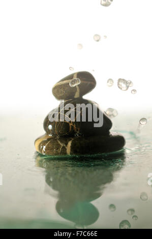 isolierte Zen Steinen in perfekter Harmonie mit fallen und Spritzwasser Dropsisolated nassen Zen Wassersteinen mit Spritzen Wassertropfen Stockfoto