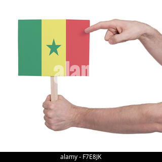 Hand, die kleine Karte, isoliert auf weiss - Flagge des Senegal Stockfoto