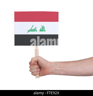 Hand, die kleine Karte, isoliert auf weiss - Flagge des Irak Stockfoto