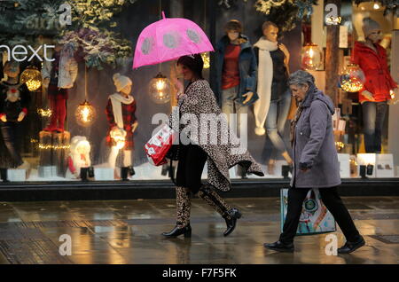 Swansea UK. Montag, 30. November 2015 weibliche Shopper mit einem Regenschirm in Oxford Street, Swansea, South Wales, als starke Winde und schwere Regen hat Auswirkungen auf die meisten Teile auf das Vereinigte Königreich. Bildnachweis: D Legakis/Alamy Live-Nachrichten Stockfoto