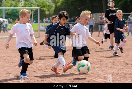 Fußballkind. Kinder spielen Fußball auf dem Sommerstadion. Kleiner