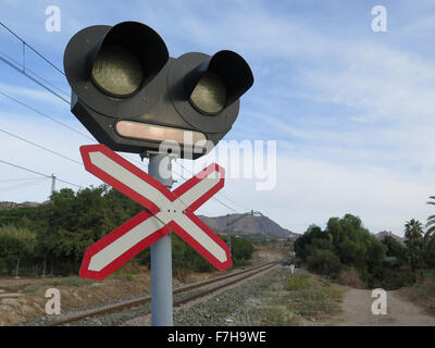 Beleuchtung und Kontrolllampe Kreuz auf unbewachten Bahnübergang im ländlichen Andalusien Stockfoto