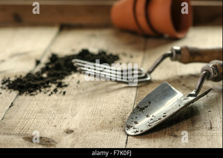 Drei Terrakotta-Töpfe auf eine Pottingbank, mit Hand-Gabel und Kelle. Stockfoto