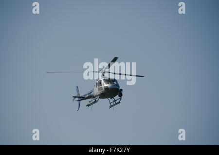 ein Hubschrauber auf einen blauen Himmel stehen noch in der Luft Stockfoto