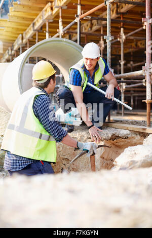 Bauarbeiter im Gespräch auf Baustelle Stockfoto