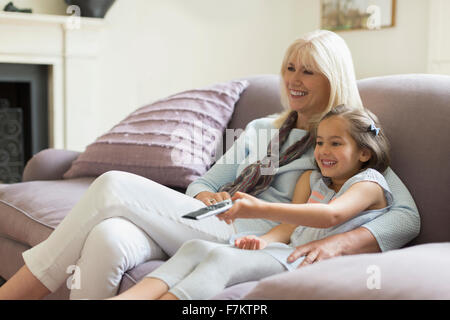 Großmutter und Enkelin vor dem Fernseher im Wohnzimmer-sofa Stockfoto