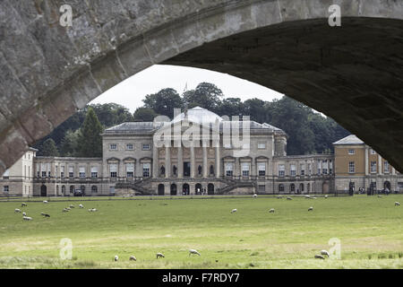 Das Haus gesehen unter einer Brücke in Kedleston Hall, Derbyshire. Kedleston ist eines der größten und vollkommensten fertigen aller Eigenschaften, die von Robert Adam entworfen. Stockfoto