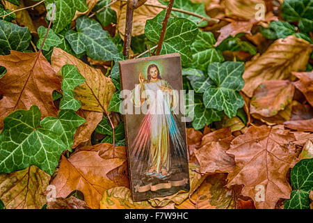 ein Symbol mit dem Bild des Barmherzigen Jesus stützte sich auf einer alten Mauer: die Multifunktionsleiste auf Unterseite ist leer Stockfoto