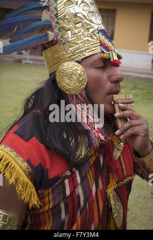 Ein Mann gekleidet in traditioneller Kleidung spielt ein Instrument Inka Anden Wind. Stockfoto