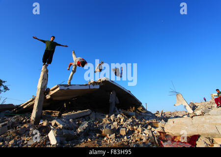 Gaza, Palästina. 5. Dezember 2015. Palästinensische Jugendliche Parkour zu üben auf den Ruinen der Häuser, die während des israelischen Angriffs auf den östlich von Khan Yunis im südlichen Gazastreifen zerstört wurden. Bildnachweis: Ramadan El-Agha/Pacific Press/Alamy Live-Nachrichten Stockfoto