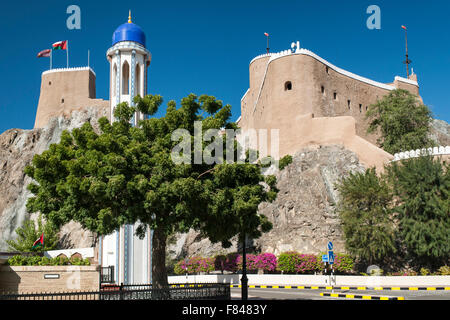 Al Mirani Fort und das Minarett der Al Khor Mosque in alten Muscat, der Hauptstadt des Sultanats Oman. Stockfoto