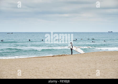 Landschaft der Songjeong Strand mit einer Frau mit Surfen Bard. Der Strand liegt in der Nähe von Busan Haeundae Strand und es hat Stockfoto