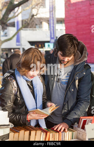 Paar Bücher am Buchmarkt in Southbank, London im Dezember anschauen Stockfoto