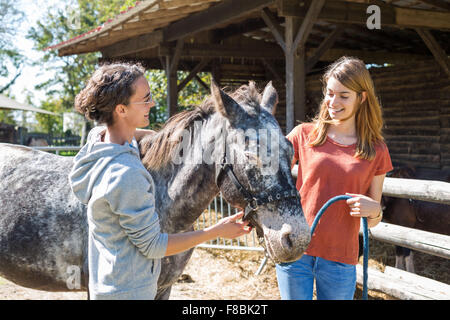 Junge Frau in Horse-Therapie-Sitzung mit einem Therapeuten, Brie de Charente Reiten, Frankreich. Stockfoto