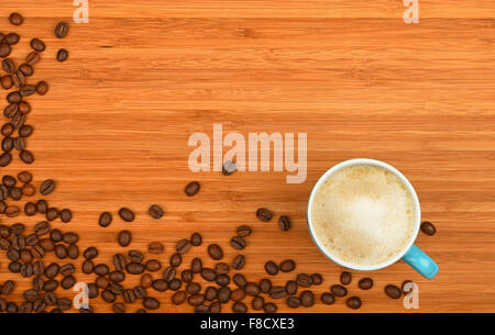 Blue Kaffeetasse Latte Cappuccino und gerösteten Arabica Bohnen Ecke Grenze über Holz Bambus Board Hintergrund geprägt Stockfoto