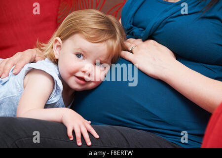 Junges Mädchen schwanger Mutter Bauch hören Stockfoto