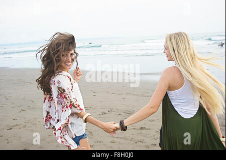 Kaukasischen Frauen Hand in Hand am Strand Stockfoto