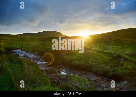 Sonnenaufgang über dem ländlichen Hügeln und stream Stockfoto