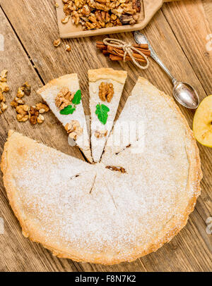 Traditioneller Apfelkuchen Dessert mit Walnüssen auf Holztisch Stockfoto