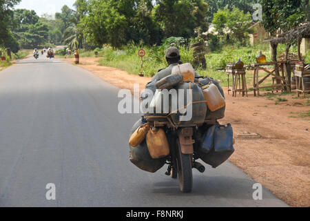 Mann auf dem Motorrad transportieren Container von Gas (Benzin, Benzin), Benin Stockfoto