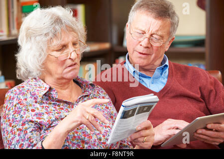 Älteres Paar versucht, Handy betreiben verwechselt Stockfoto