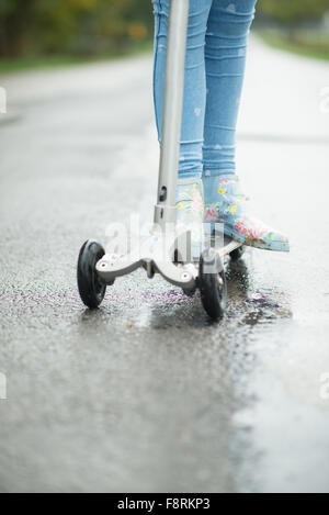 Geringen Teil ein Mädchen stehen auf Push scooter Stockfoto