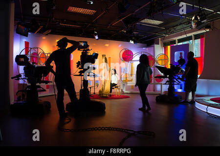 Zwei Kameramännern und weibliche Studio Stock Manager bei der Arbeit während der Ausstrahlung einer live tv-Programm auf Walisisch TV-Sender S4C aus den Studios von "Heno" im Media Center Tinoplis, Llanelli, South Wales Stockfoto